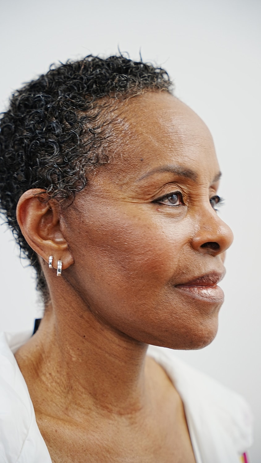 Profile of a woman with short curly hair.
