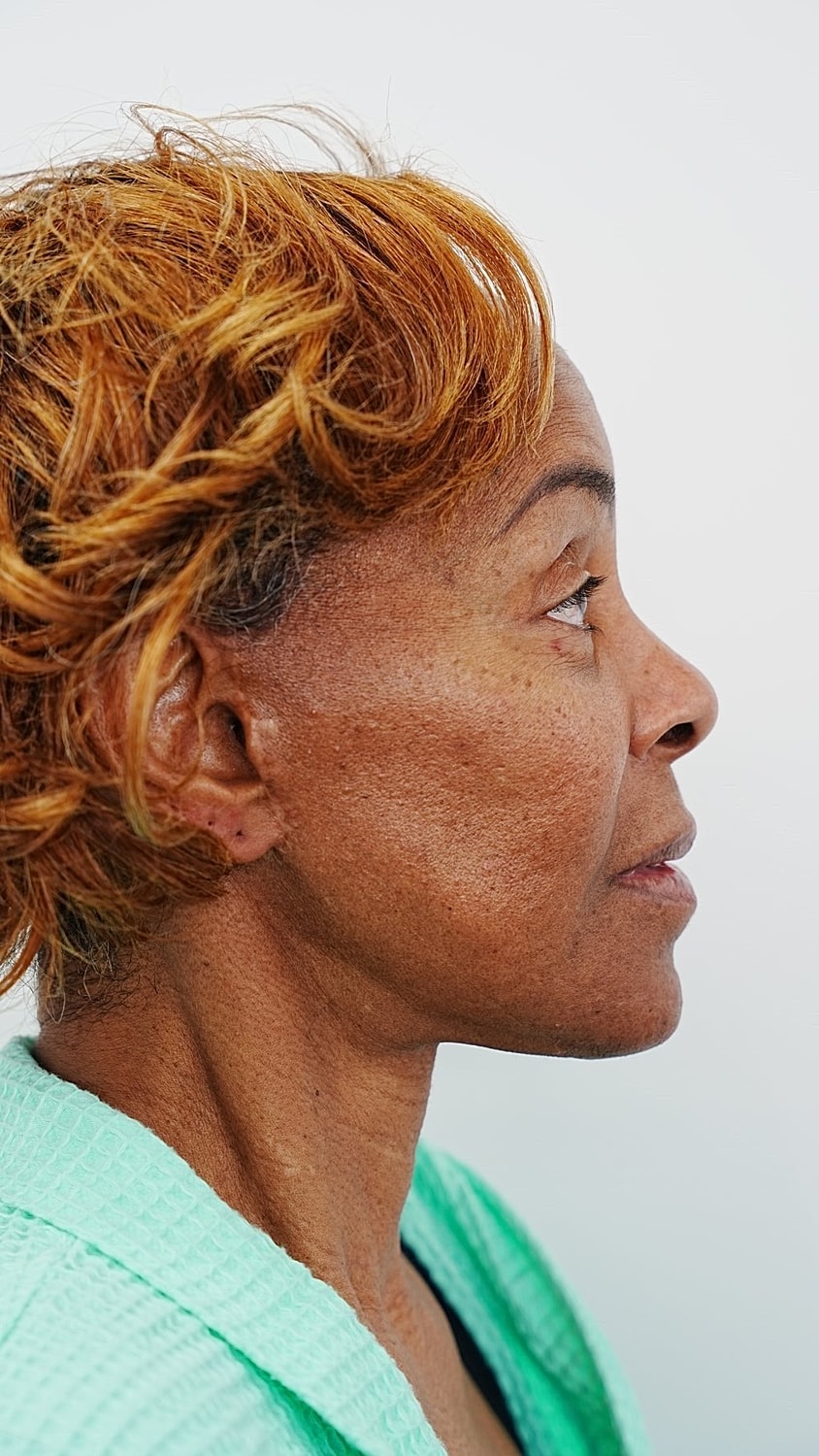 Profile of a woman with curly short hair.