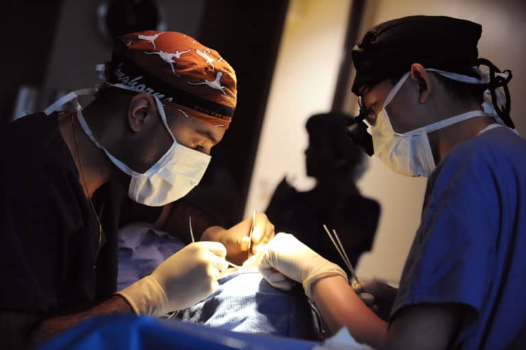 two doctors performing surgery