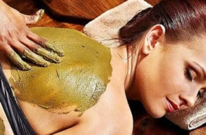 woman laying down getting a back facial