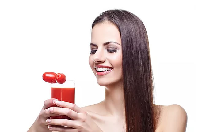 woman with glass of tomato juice