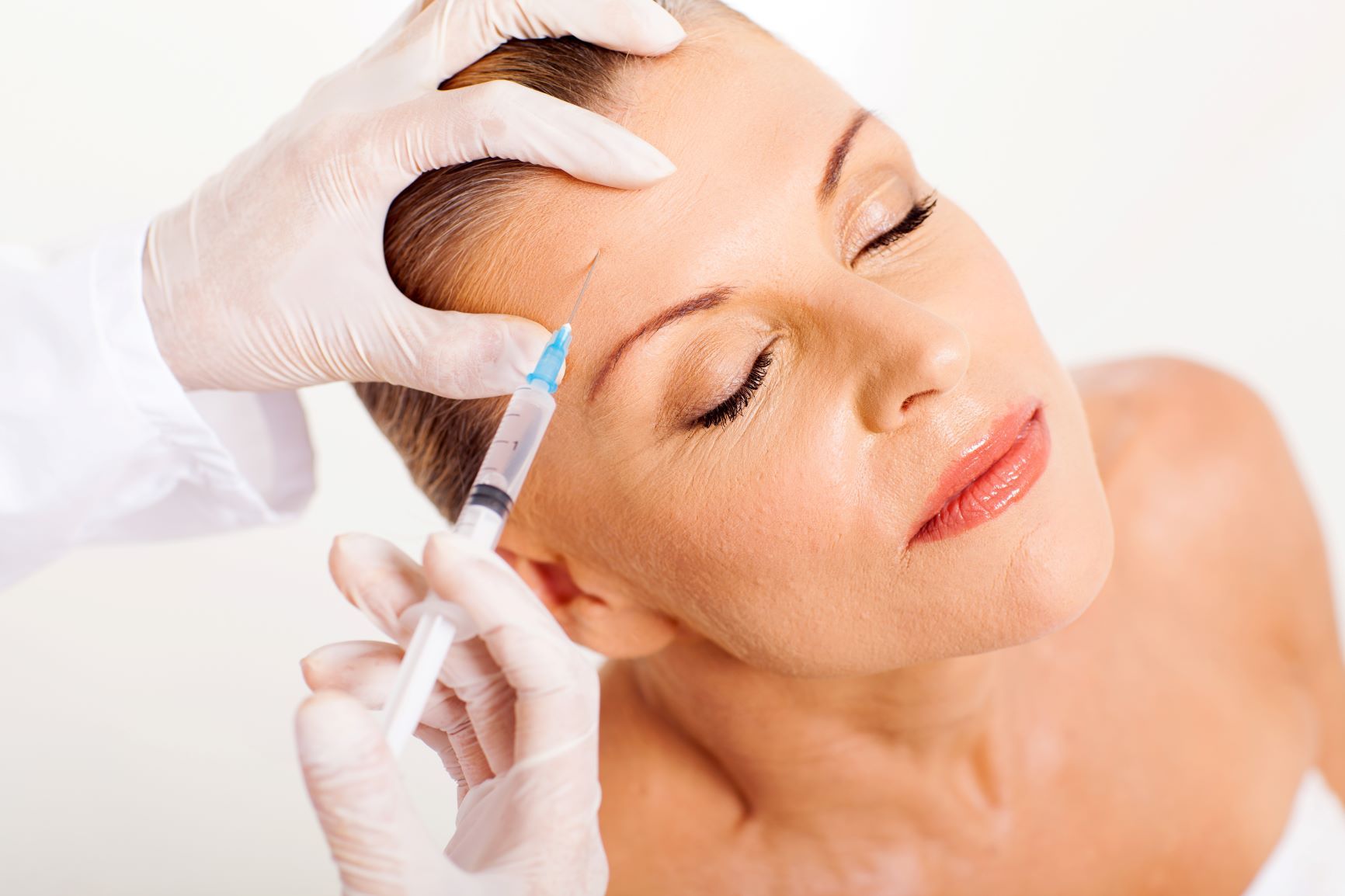 woman receiving injectables in her forehead