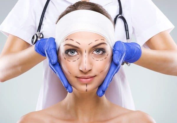 woman with face marked up by marker in prep for surgery