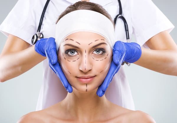 woman with face marked up with a marker in prep for surgery