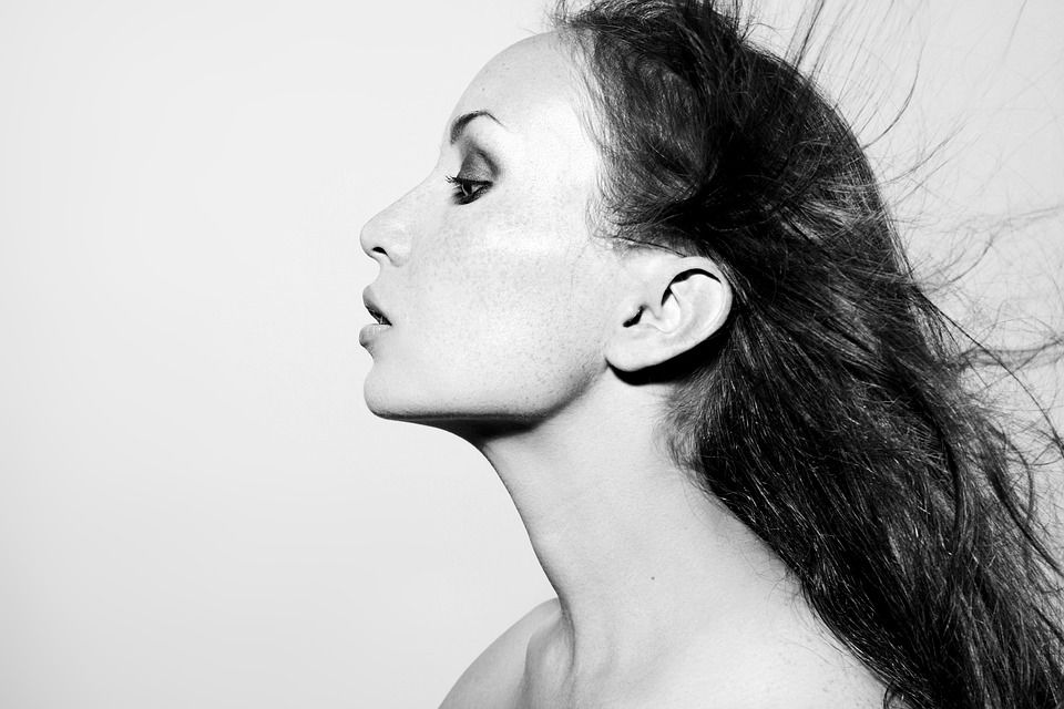 black and white photo of a woman in profile with clear skin